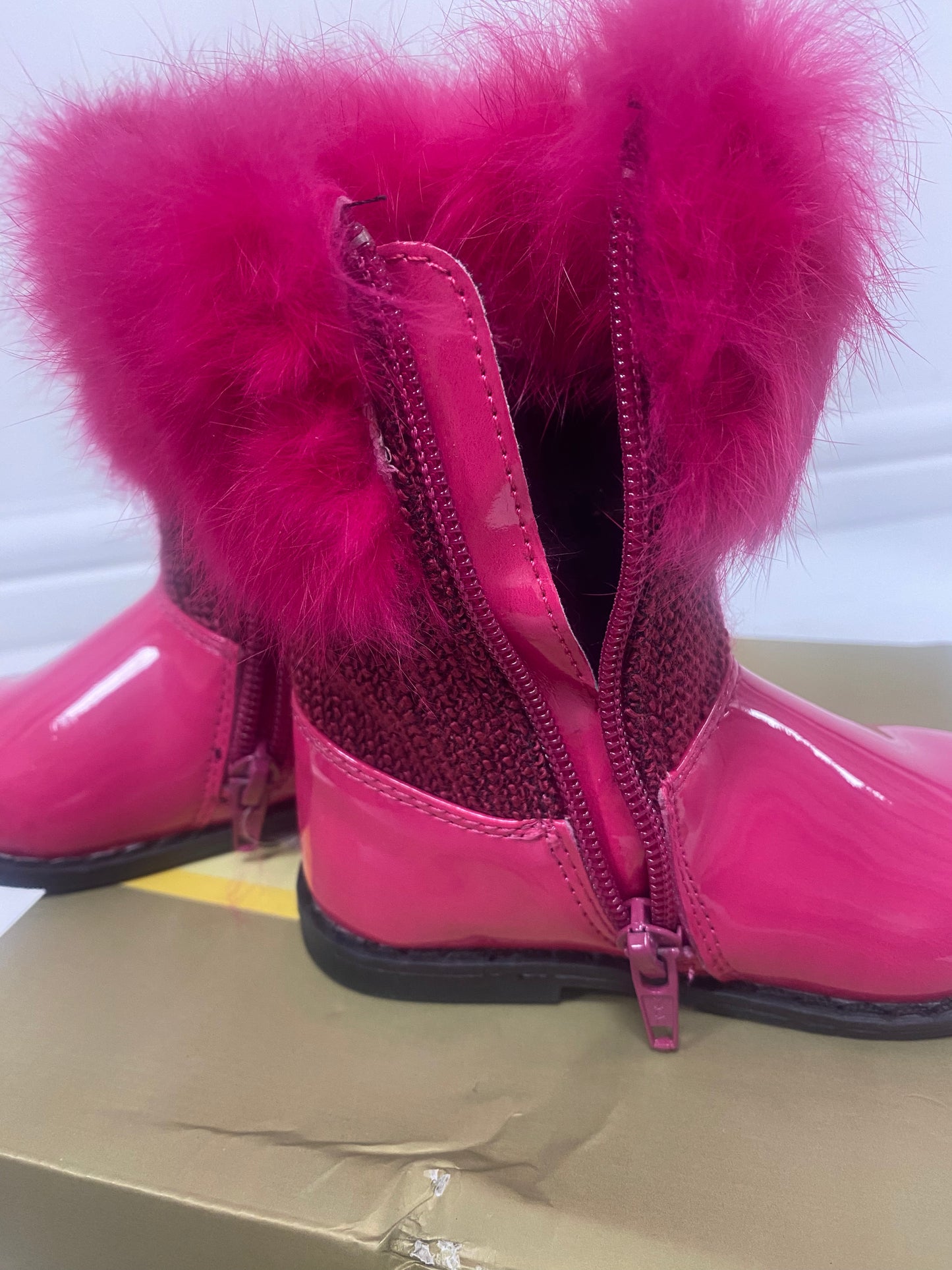 Bright pink faux fur top boots